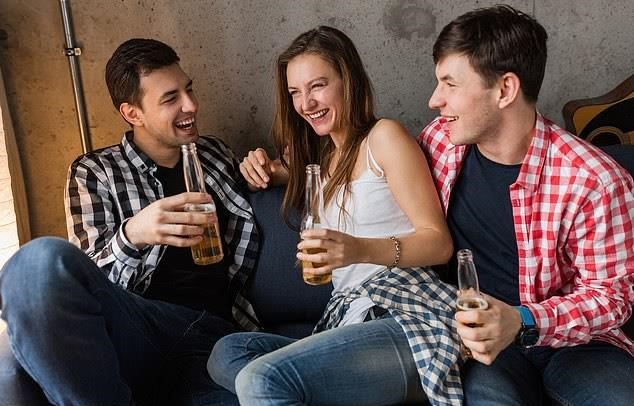 Two Men One Woman Laughing and Having Drinks