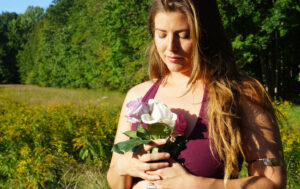 Amanda Ananda holding roses in field Amanda Ananda holding roses in field